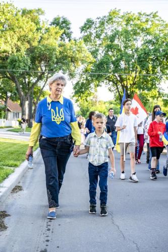 Mary Jane Kalenchuk guiding a boy during the procession